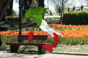 giardino con tulipani come sfondo e cartina dell'italia in primo piano