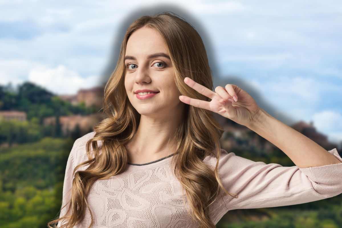 montepulciano sullo sfondo e donna in segno di vittoria